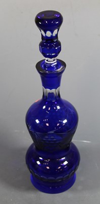 Lot 37 - A cut blue overlaid glass decanter and stopper,...