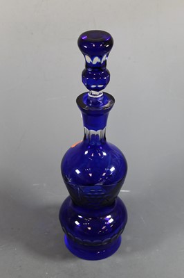Lot 37 - A cut blue overlaid glass decanter and stopper,...