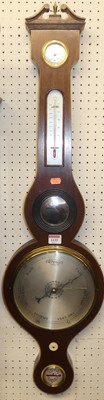 Lot 1135 - A reproduction mahogany four dial wheel...