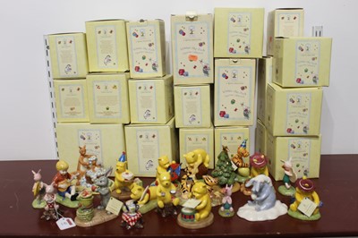 Lot 63 - A collection of 20 Winnie The Pooh figures, to...