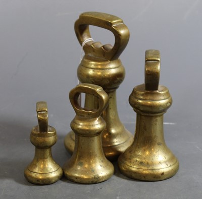Lot 69 - A set of four graduated brass bell weights,...