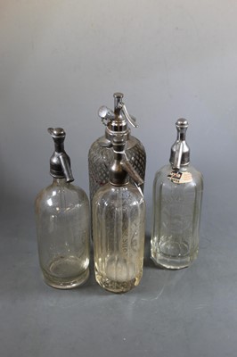 Lot 92 - A pair of clear glass soda siphons, each...