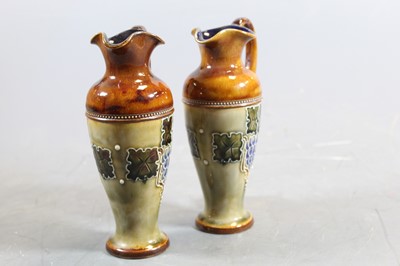 Lot 247 - A pair of Royal Doulton miniature ewers, with...