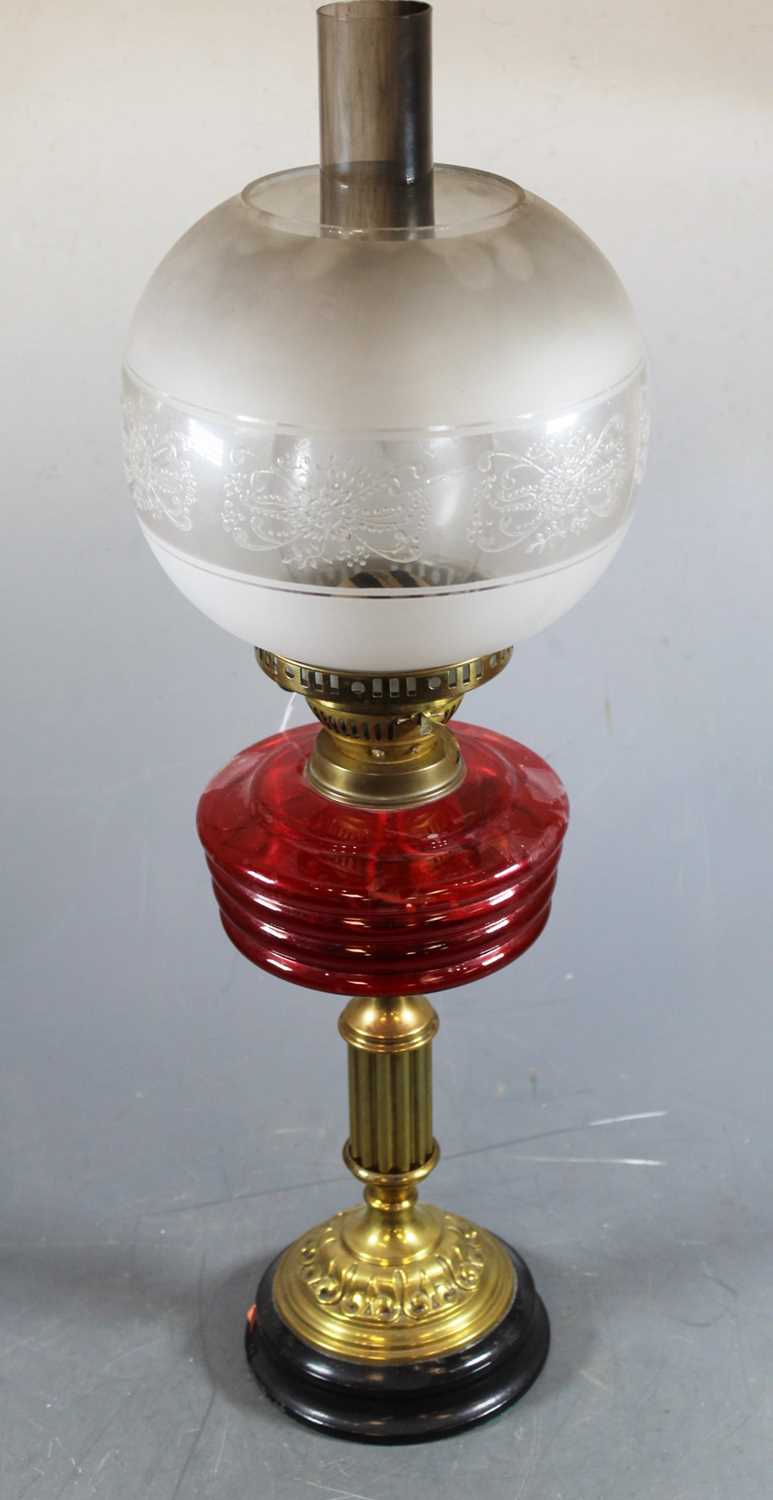 Lot 143 - An early 20th century brass pedestal oil lamp...