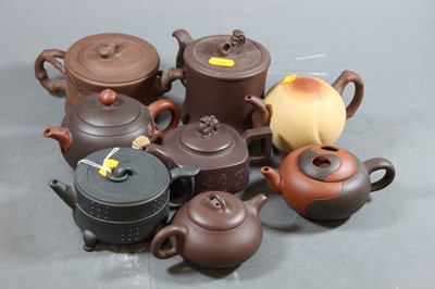 Lot 145 - A collection of eight Chinese teapots and...