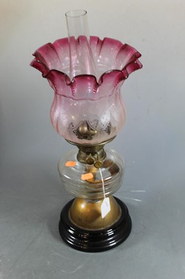 Lot 150 - A 19th century glass oil lamp, the cranberry...