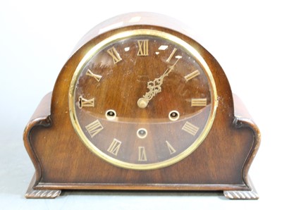 Lot 199 - A 1950s oak cased mantel clock having raised...