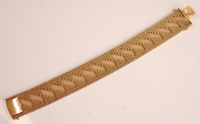 Lot 1090 - A yellow metal interwoven meshlink bracelet,...