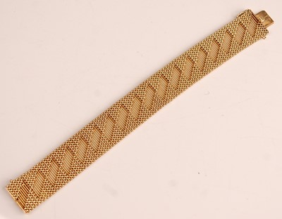 Lot 1090 - A yellow metal interwoven meshlink bracelet,...