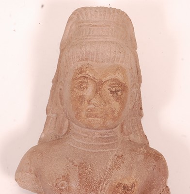 Lot 131 - A red sandstone figure of a deity in standing...