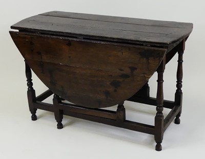 Lot 1344 - A circa 1700 joined oak gateleg table, having...