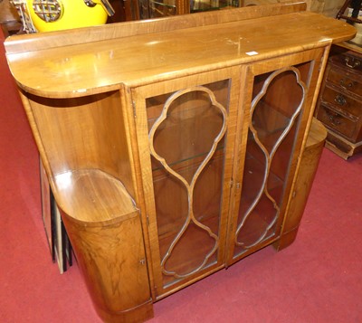 Lot 391 - An Art Deco figured walnut round cornered...