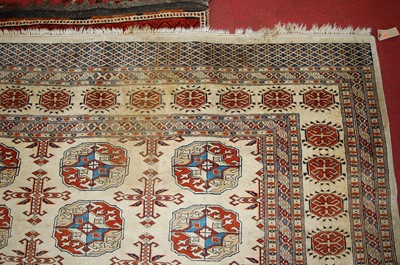 Lot 1366 - A Persian woollen cream ground Bokhara rug,...