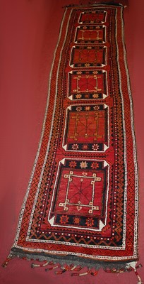 Lot 1367 - A Turkish woollen hall runner, the red ground...