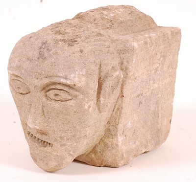 Lot 437 - * A limestone block, carved as a male head...