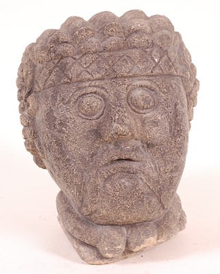 Lot 2436 - A carved limestone male head, having stylized...