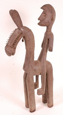 Lot 142 - * A large carved wooden stylized horseman...