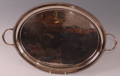 Lot 1049 - A George V silver twin handled oval tray,...