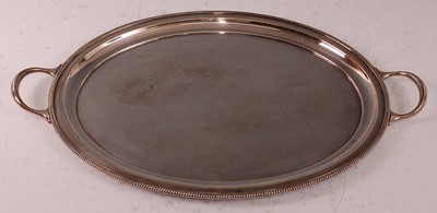 Lot 1049 - A George V silver twin handled oval tray,...