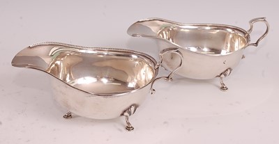 Lot 1054 - A near-pair of George V silver sauce-boats, of...