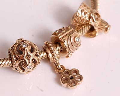 Lot 1134 - A 14ct yellow gold Pandora charm bracelet with...