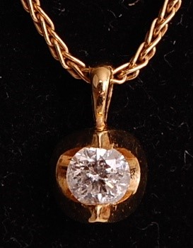 Lot 1102 - An 18ct yellow gold abstract diamond pendant,...