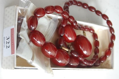 Lot 322 - A beaded cherry amber single string necklace,...