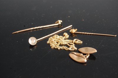 Lot 324 - A yellow metal and moonstone set tie-pin;...
