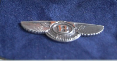 Lot 350 - A silver Bentley wings pin badge, w.38mm