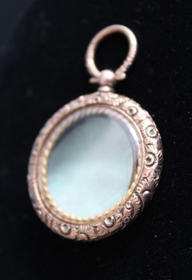Lot 361 - A Victorian pinchbeck pendant, having engine...