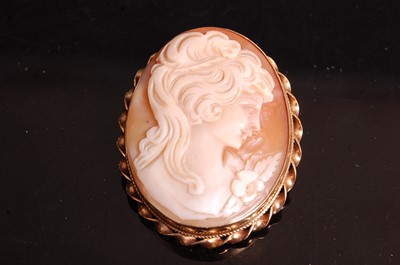 Lot 376 - A carved shell cameo brooch, in 9ct gold...