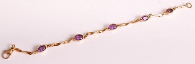 Lot 1136 - An 18ct yellow gold and amethyst bracelet,...