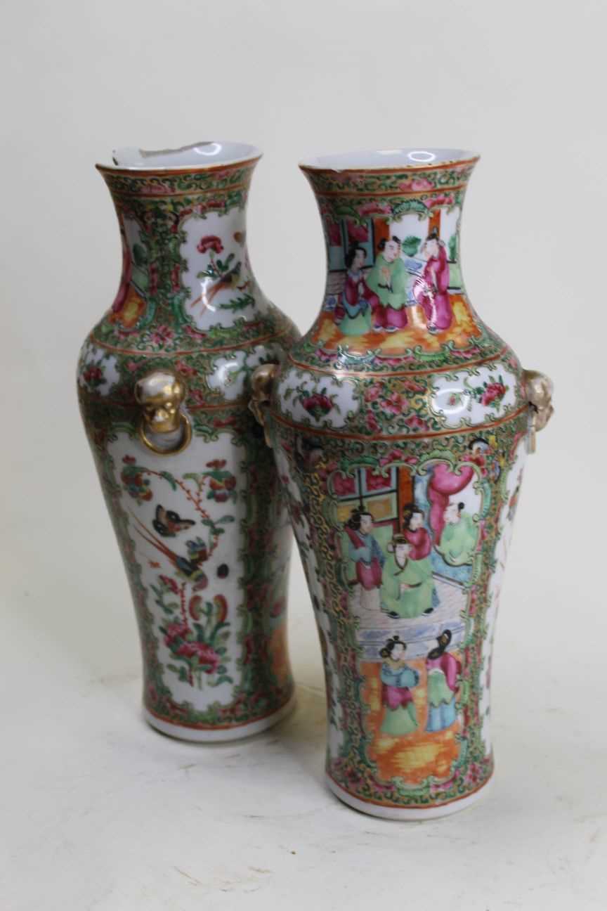 Lot 11 - A pair of late Qing Dynasty famille rose vases,...