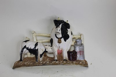 Lot 19 - A cast iron doorstop in the form of a cow and...