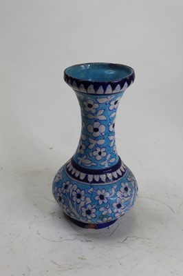 Lot 30 - An Iznik style blue glazed twin handled urn,...