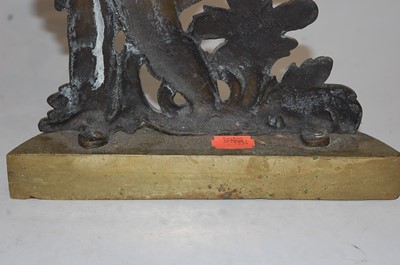 Lot 105 - A 19th century brass doorstop, the C-scroll...