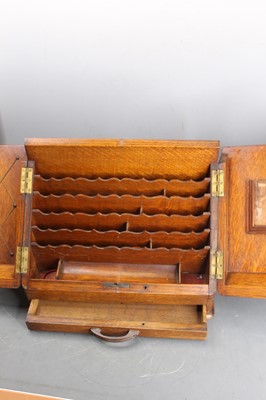 Lot 122 - A late Victorian oak table-top stationery...