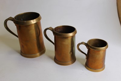 Lot 143 - Three 19th century brass graduated tankards,...