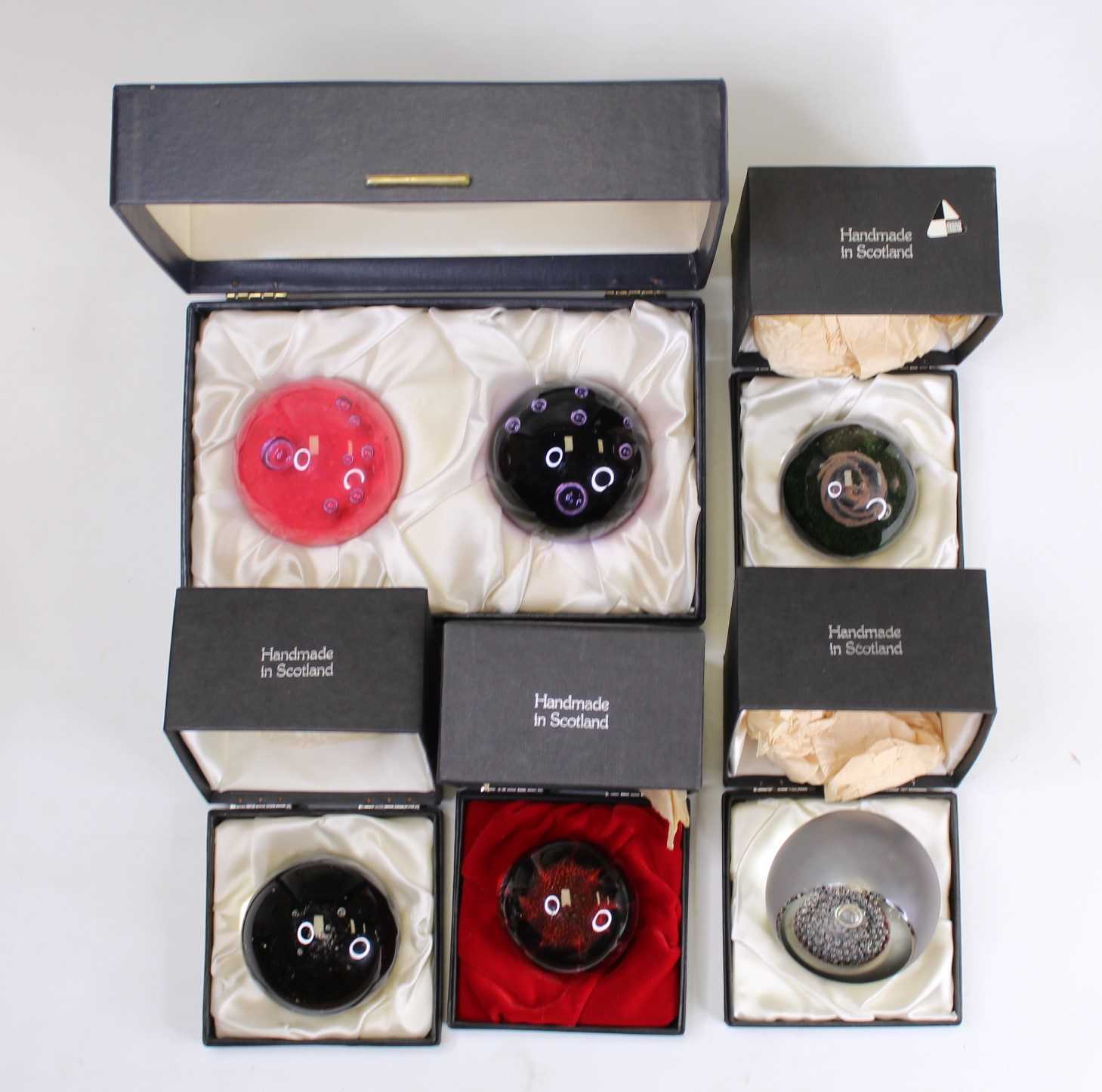 Lot 176 - A collection of six glass paperweights to...