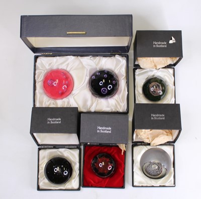 Lot 176 - A collection of six glass paperweights to...