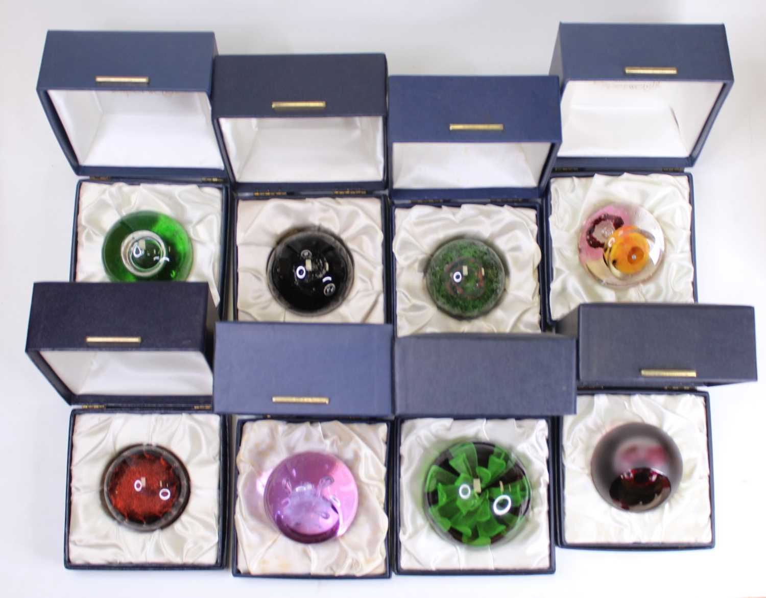 Lot 179 - A collection of eight glass paperweights to...