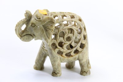 Lot 239 - A 20th century resin figure of an elephant,...