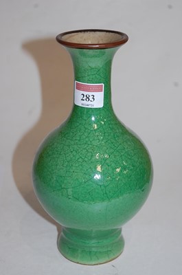 Lot 283 - A green crackle glazed vase having a flared...