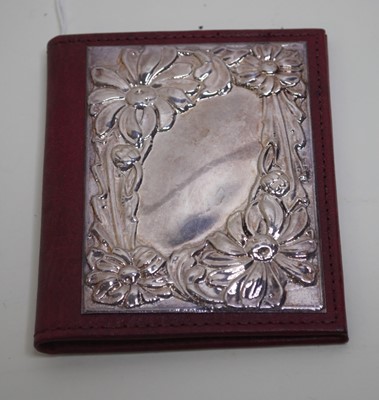 Lot 460 - A red leather wallet, having a silver panel...