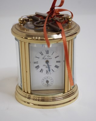 Lot 455 - A French lacquered brass cased carriage clock,...