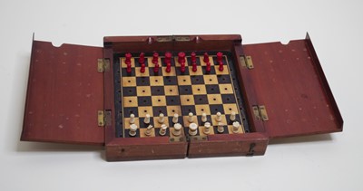 Lot 469 - A circa 1900 mahogany cased travelling chess...