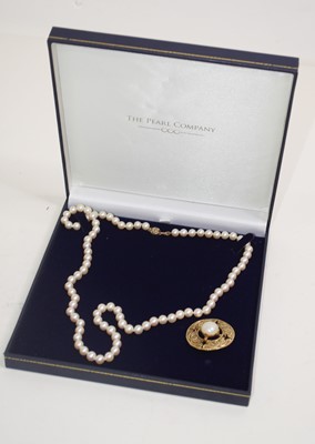 Lot 498 - A cultured blue pearl necklace in leather case...