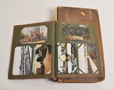 Lot 578 - An early 20th century postcard album and...