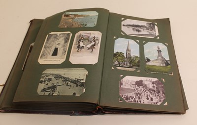 Lot 641 - An early 20th century postcard album, the...