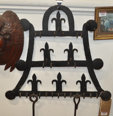 Lot 650 - A 19th century wrought iron hanging rack,...